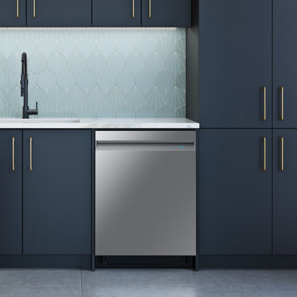 A silver Samsung dishwasher installed under a counter next to blue cabinets