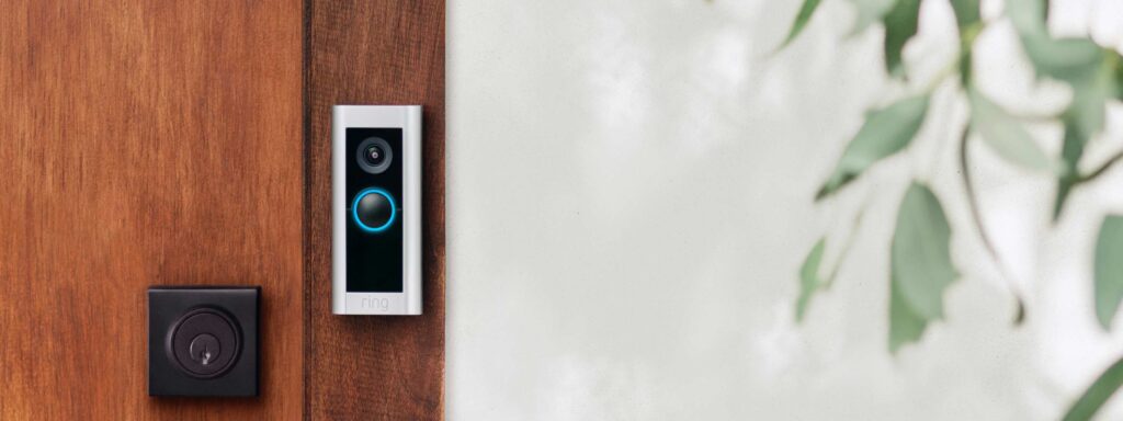 Ring Video Doorbell Pro 2 mounted on a dark brown doorframe.