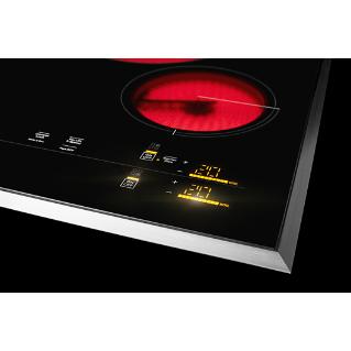 A JennAir electric coil cooktop with the PowerBurner turned on.