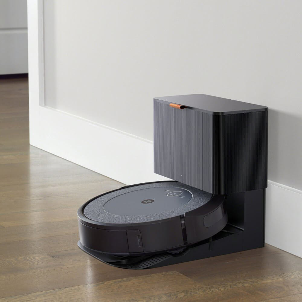 A self-emptying iRobot Roomba docked at its self-emptying station.