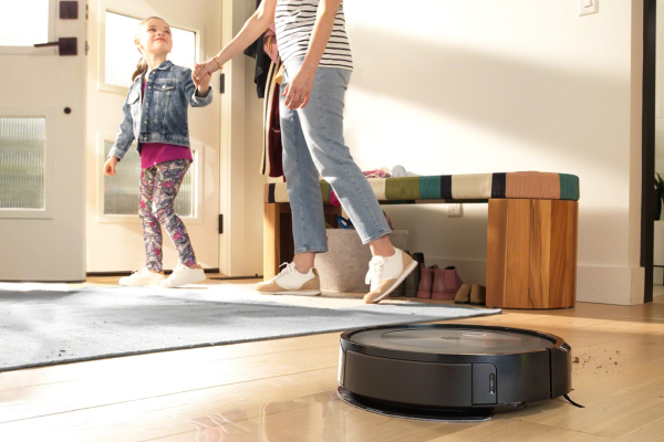 A robot vacuum with mop functions cleaning hardwood floors.