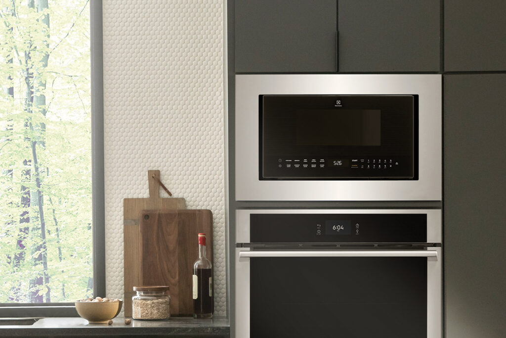 An Electrolux microwave installed in kitchen cabinetry above a wall oven.